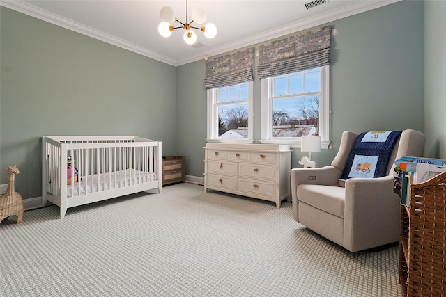 carpeted bedroom featuring crown molding, an inviting chandelier, and a crib