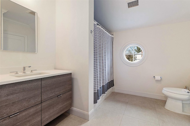 bathroom featuring toilet, tile patterned floors, vanity, and curtained shower