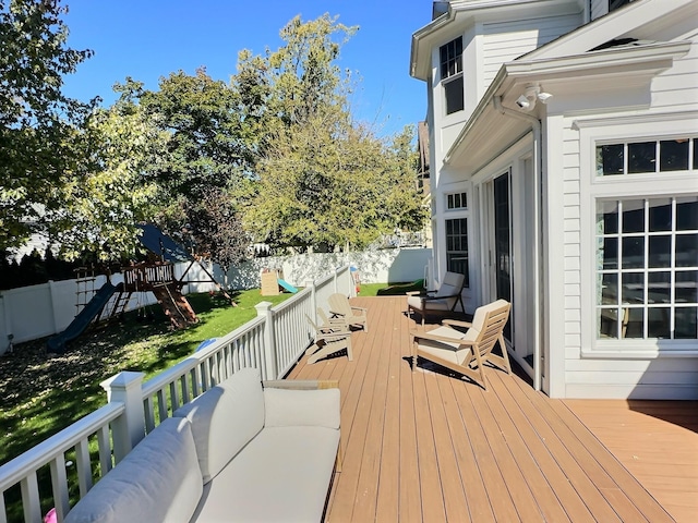 deck with outdoor lounge area and a playground