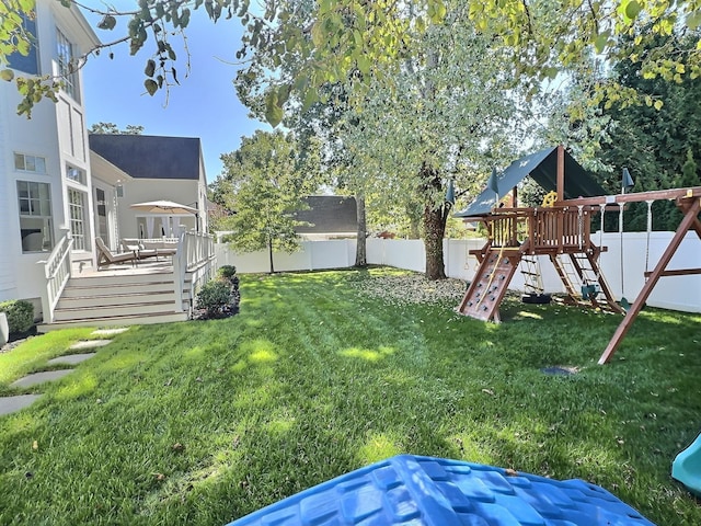 view of yard with a playground and a deck