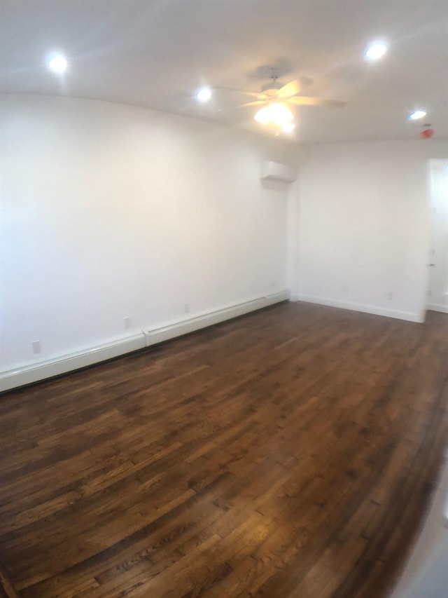 spare room featuring ceiling fan and dark hardwood / wood-style floors