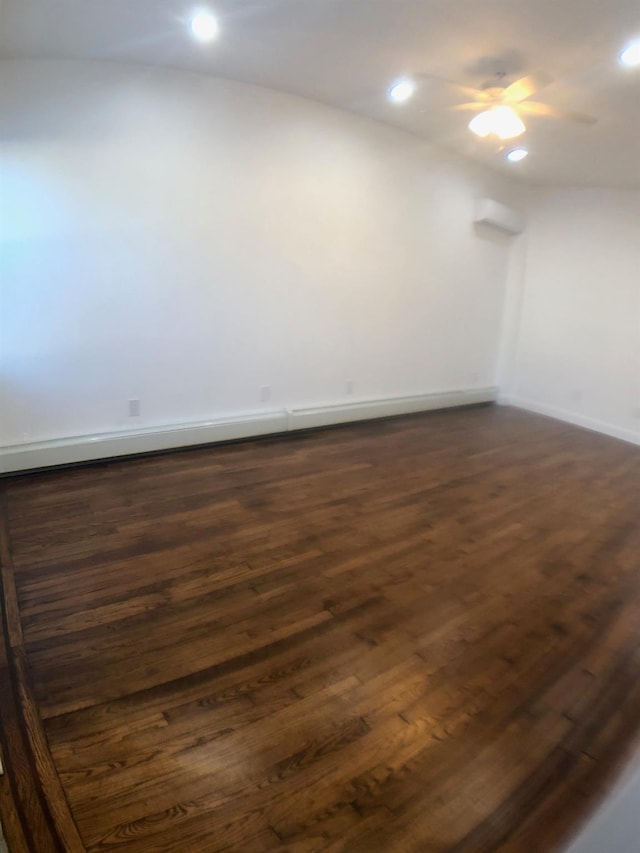 empty room featuring ceiling fan and dark hardwood / wood-style flooring