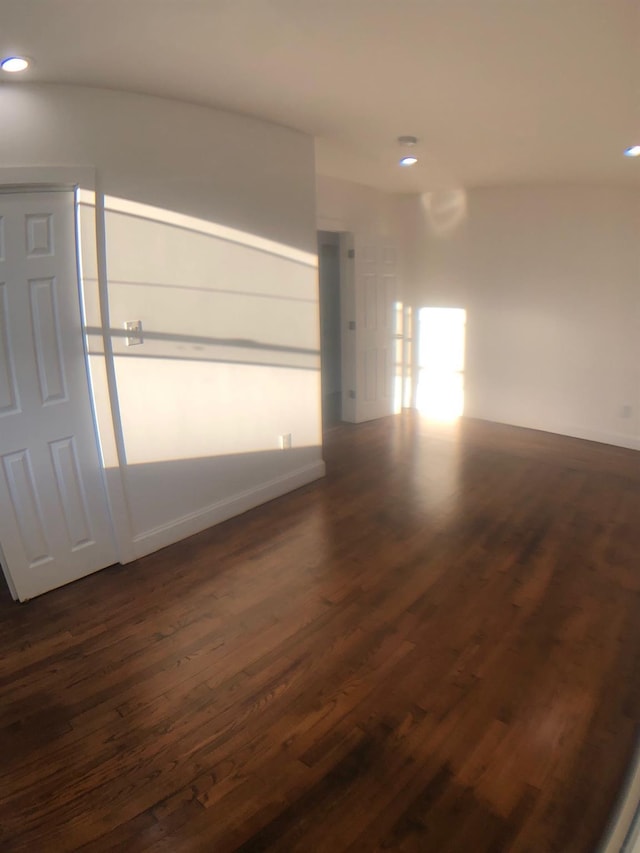 empty room featuring dark hardwood / wood-style flooring