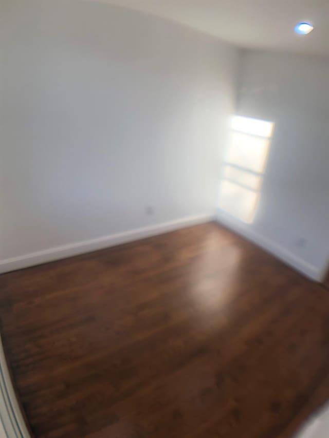 spare room featuring dark hardwood / wood-style flooring