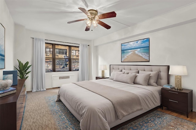 bedroom with radiator and ceiling fan