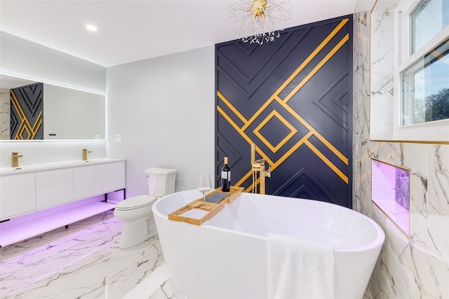 bathroom with toilet, vanity, and a tub to relax in