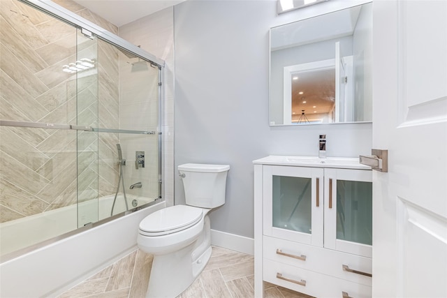 full bathroom with toilet, vanity, and shower / bath combination with glass door