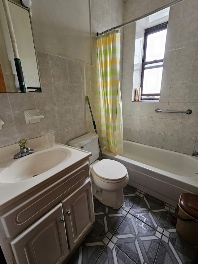 full bathroom featuring toilet, vanity, tile walls, and shower / bath combo