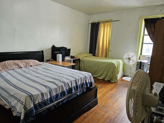 bedroom with hardwood / wood-style floors