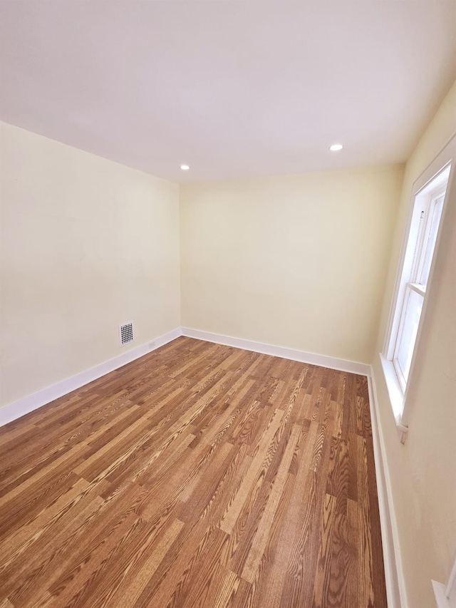 spare room featuring wood-type flooring