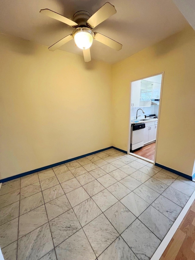 empty room with ceiling fan and sink