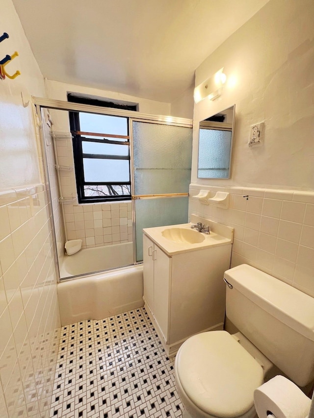 full bathroom featuring tile walls, enclosed tub / shower combo, toilet, and tile patterned flooring