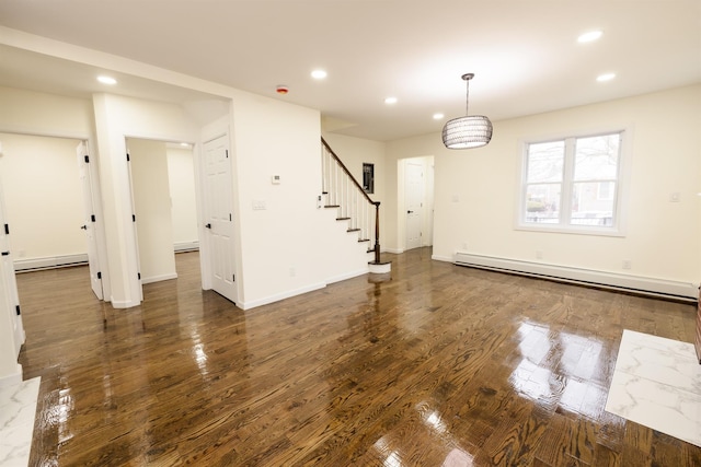 interior space featuring a baseboard heating unit and dark hardwood / wood-style flooring