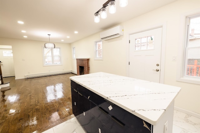 kitchen with a wall mounted AC, a brick fireplace, decorative light fixtures, a baseboard radiator, and a center island