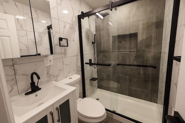 bathroom featuring vanity, backsplash, tile walls, walk in shower, and toilet