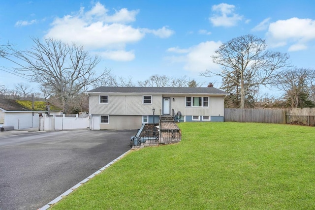 raised ranch with a front yard