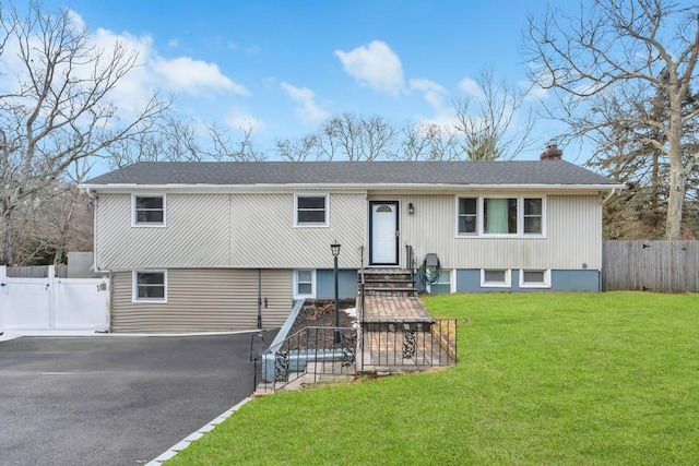 bi-level home with a front lawn