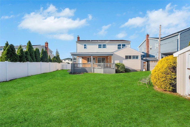 rear view of property featuring a yard