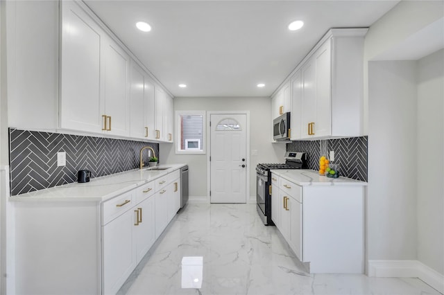 kitchen featuring sink, stainless steel appliances, white cabinets, and light stone countertops