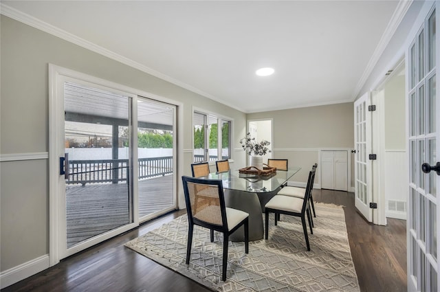 dining space with french doors, ornamental molding, and dark hardwood / wood-style flooring