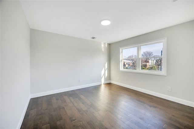 spare room featuring dark hardwood / wood-style flooring