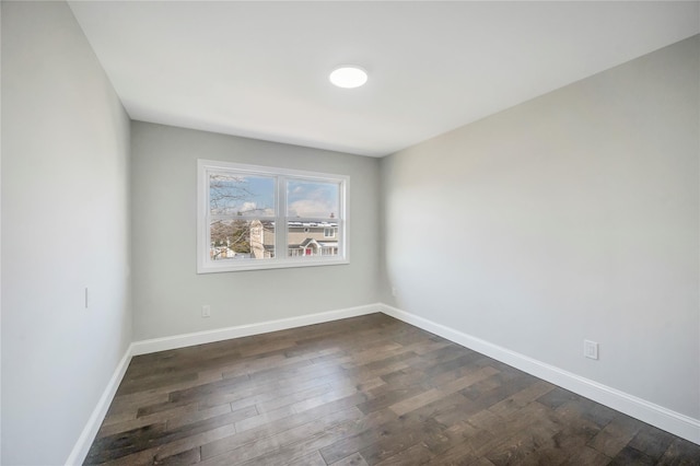 spare room with dark hardwood / wood-style flooring