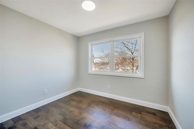 unfurnished room with dark hardwood / wood-style flooring