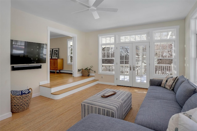 living room featuring french doors, a baseboard radiator, ceiling fan, and light hardwood / wood-style flooring