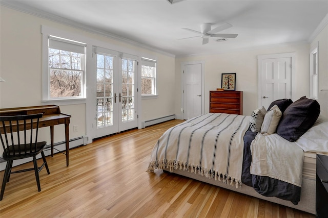 bedroom featuring multiple windows, a baseboard radiator, ceiling fan, and light hardwood / wood-style flooring