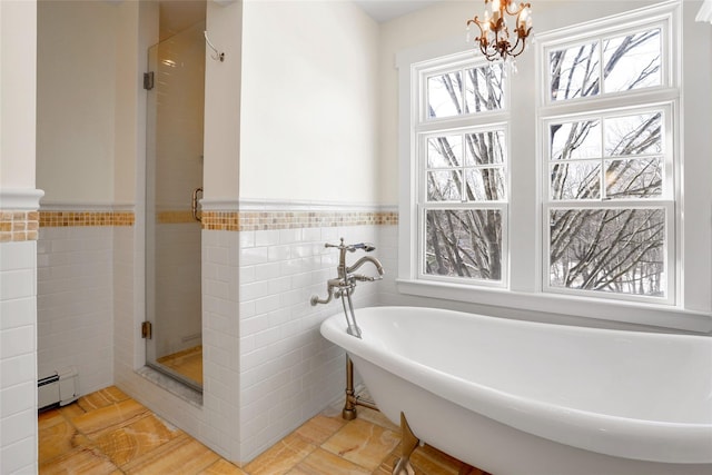 bathroom with independent shower and bath, a baseboard radiator, tile walls, and a chandelier