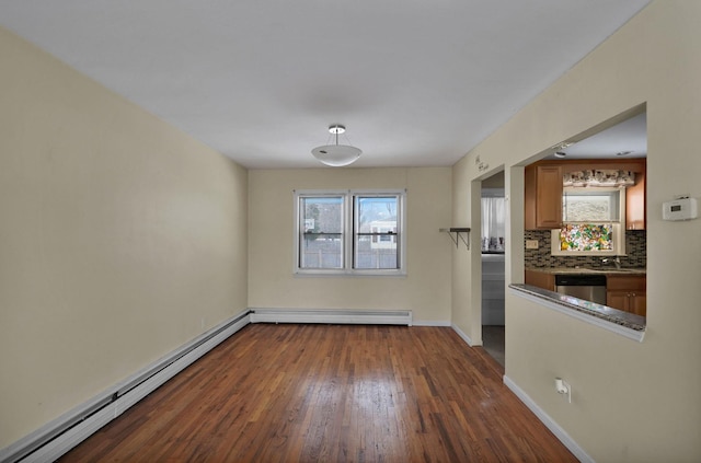 kitchen with a baseboard heating unit, tasteful backsplash, dark hardwood / wood-style flooring, dishwasher, and sink