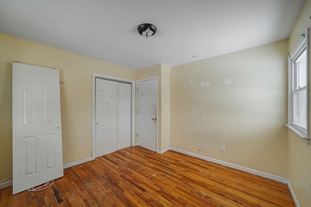 unfurnished bedroom with hardwood / wood-style floors