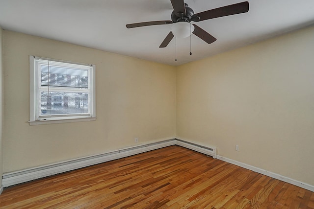 empty room with light hardwood / wood-style floors, a baseboard radiator, and ceiling fan