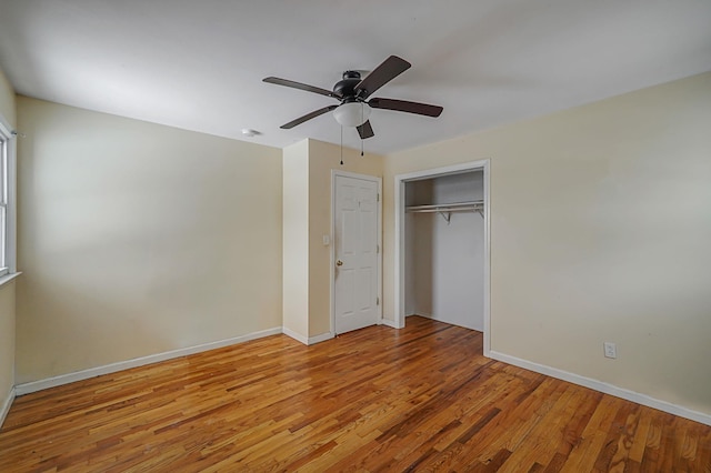 unfurnished bedroom with ceiling fan, light hardwood / wood-style flooring, and a closet