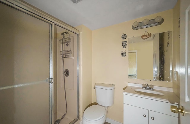 bathroom featuring walk in shower, vanity, and toilet