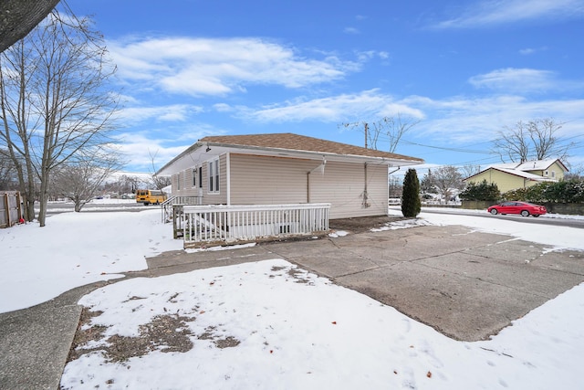 snow covered property featuring a porch