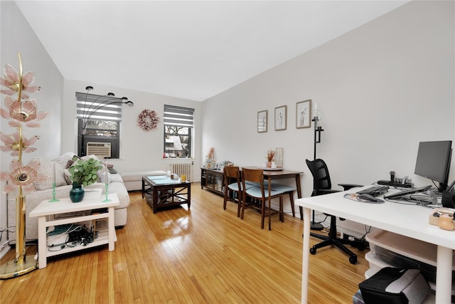 home office featuring radiator and hardwood / wood-style floors