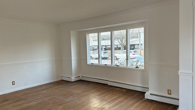 empty room with a baseboard heating unit, dark hardwood / wood-style flooring, and crown molding