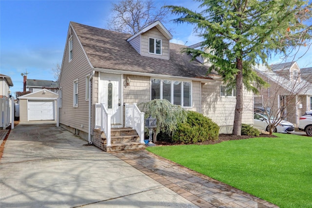 view of front facade featuring a garage, an outbuilding, and a front yard