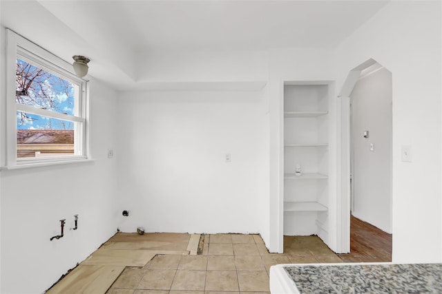 laundry room with light tile patterned flooring and built in features