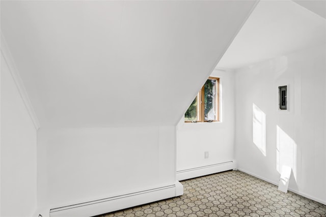 additional living space featuring lofted ceiling and baseboard heating