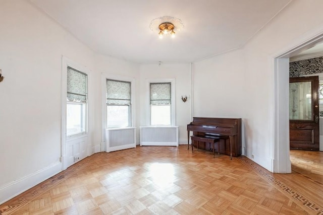 interior space featuring light parquet flooring and radiator heating unit