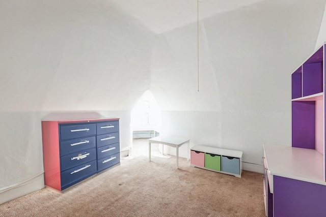 interior space featuring light carpet and vaulted ceiling