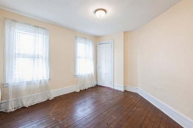 spare room featuring dark wood-type flooring