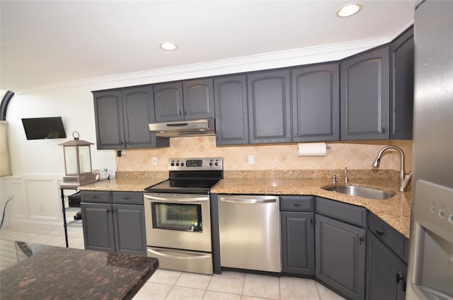 kitchen featuring crown molding, appliances with stainless steel finishes, sink, light tile patterned floors, and light stone counters