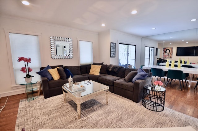 living room with hardwood / wood-style flooring and ornamental molding