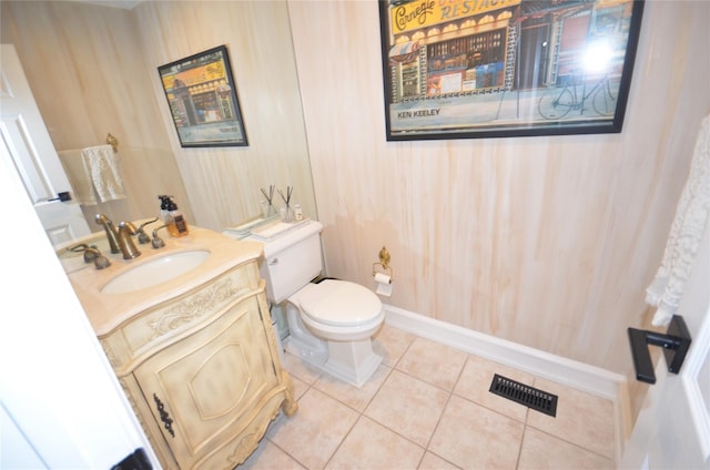 bathroom with vanity, toilet, and tile patterned floors