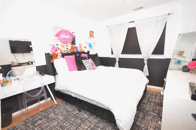 bedroom with wood-type flooring