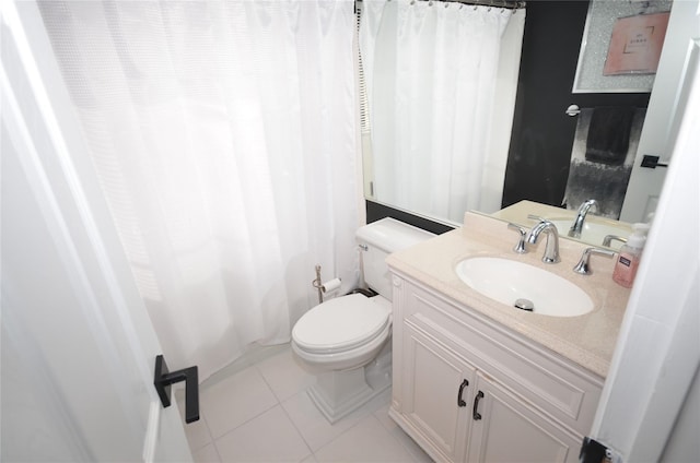 bathroom featuring toilet, tile patterned floors, and vanity