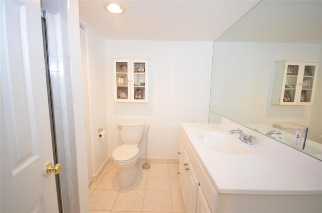 bathroom featuring toilet, tile patterned floors, and vanity